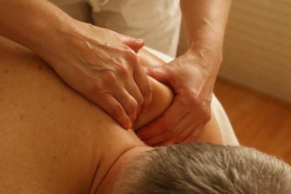 A close up image of someone receiving a deep tissue massage on their shoulder